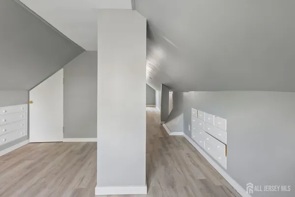 a view of hallway with wooden floor