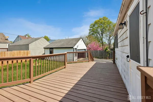 a view of balcony with wooden floor and fence