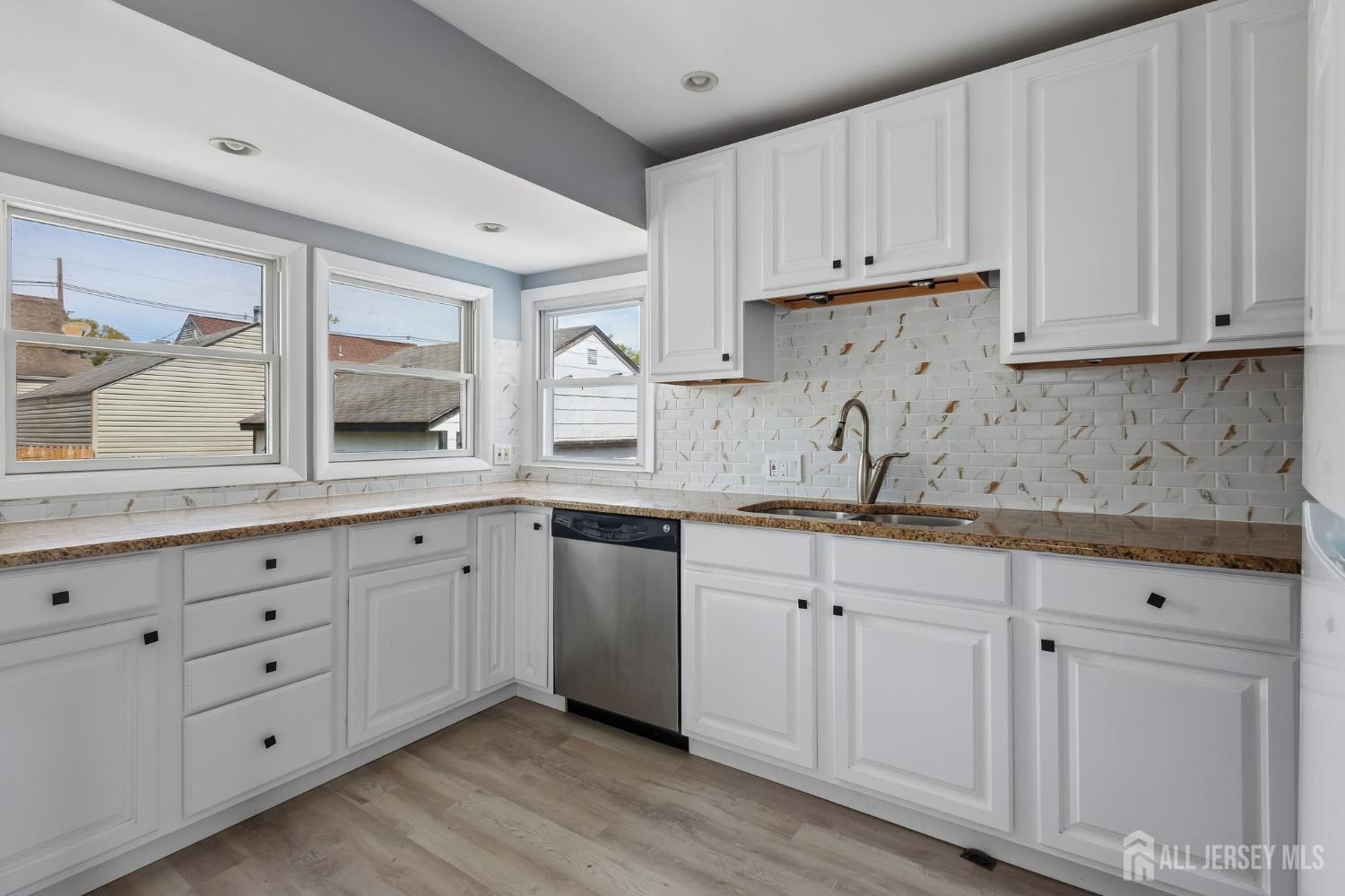 2 Westbury Road Iselin, NJ 08830 - Photo 10 of 25 a kitchen with granite countertop white cabinets and sink