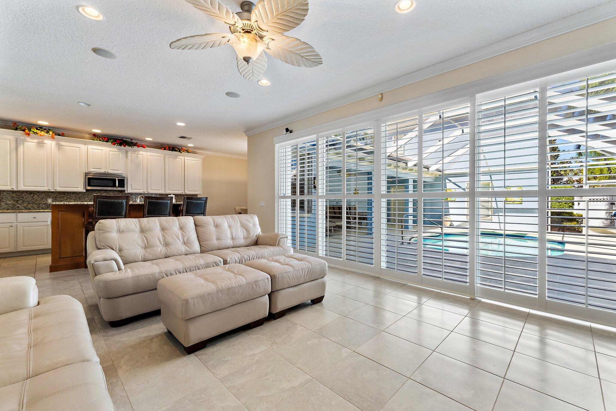 115 Castries Drive Jupiter, FL 33458 - Photo 12 of 60 a living room with furniture and a large window