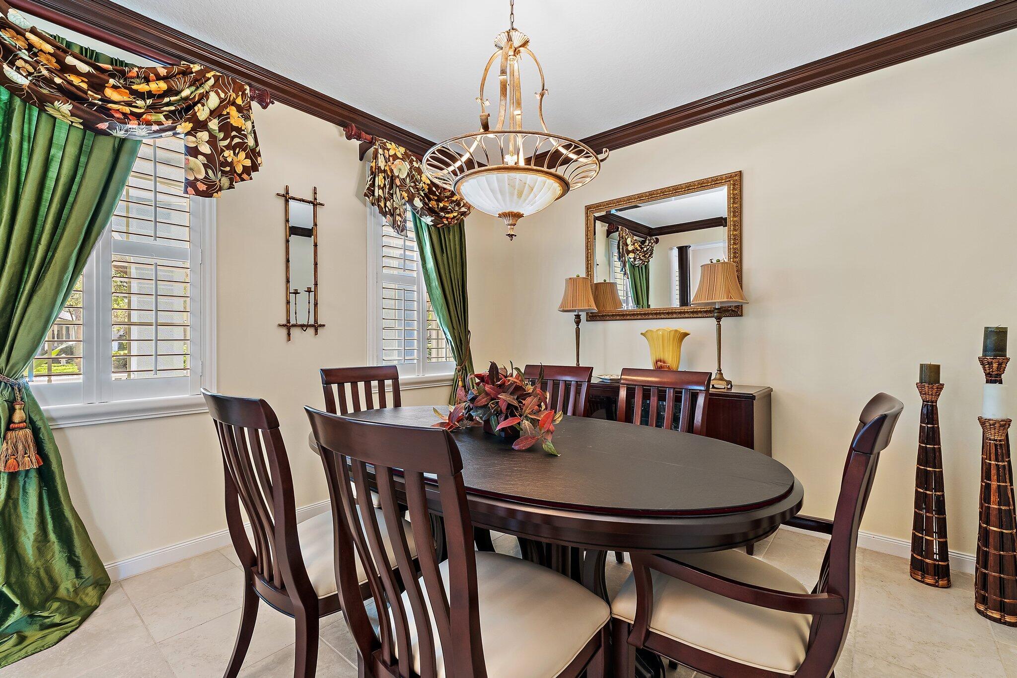 115 Castries Drive Jupiter, FL 33458 - Photo 18 of 60 a view of a dining room with furniture and a chandelier