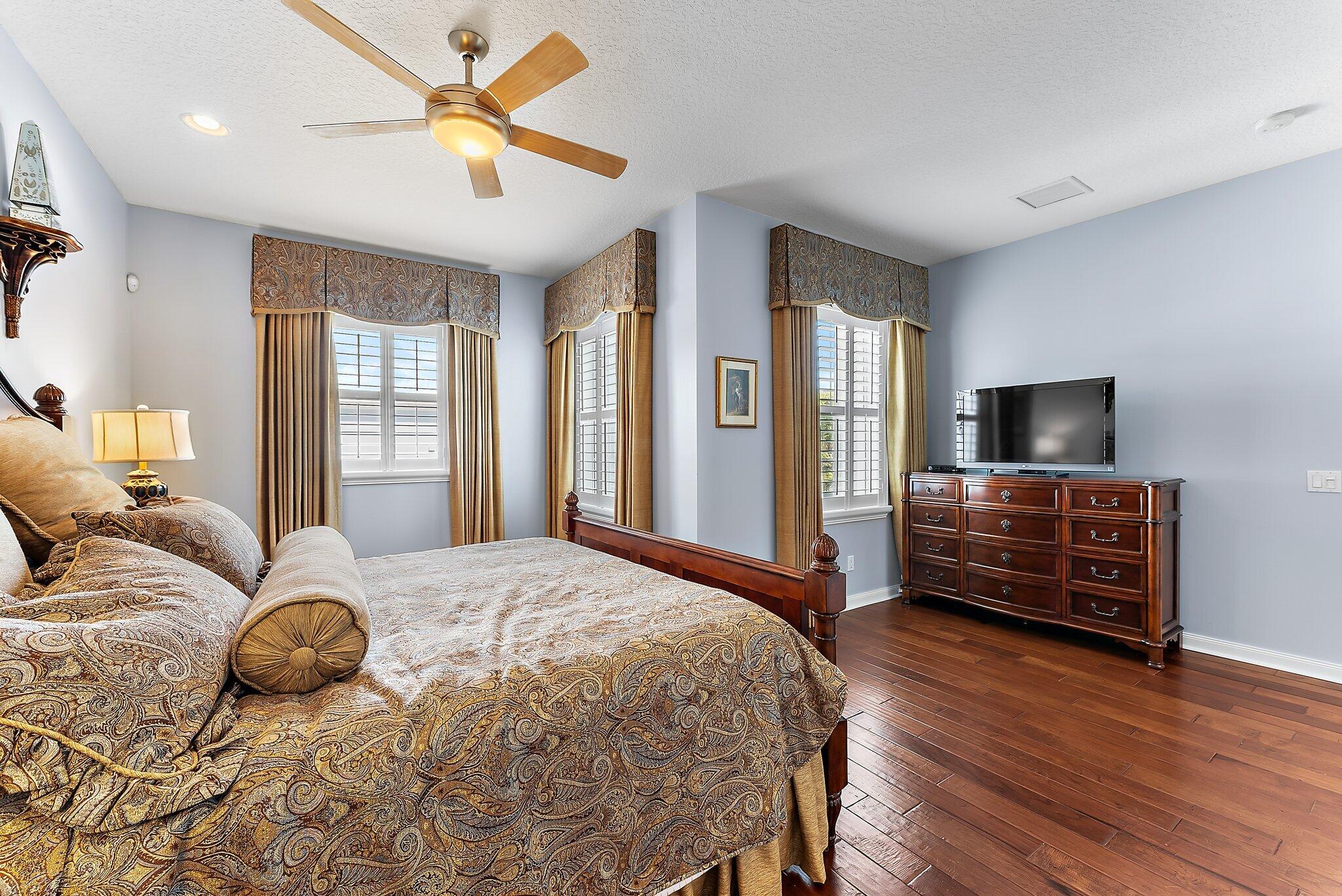 115 Castries Drive Jupiter, FL 33458 - Photo 27 of 60 a bedroom with a bed and a flat screen tv
