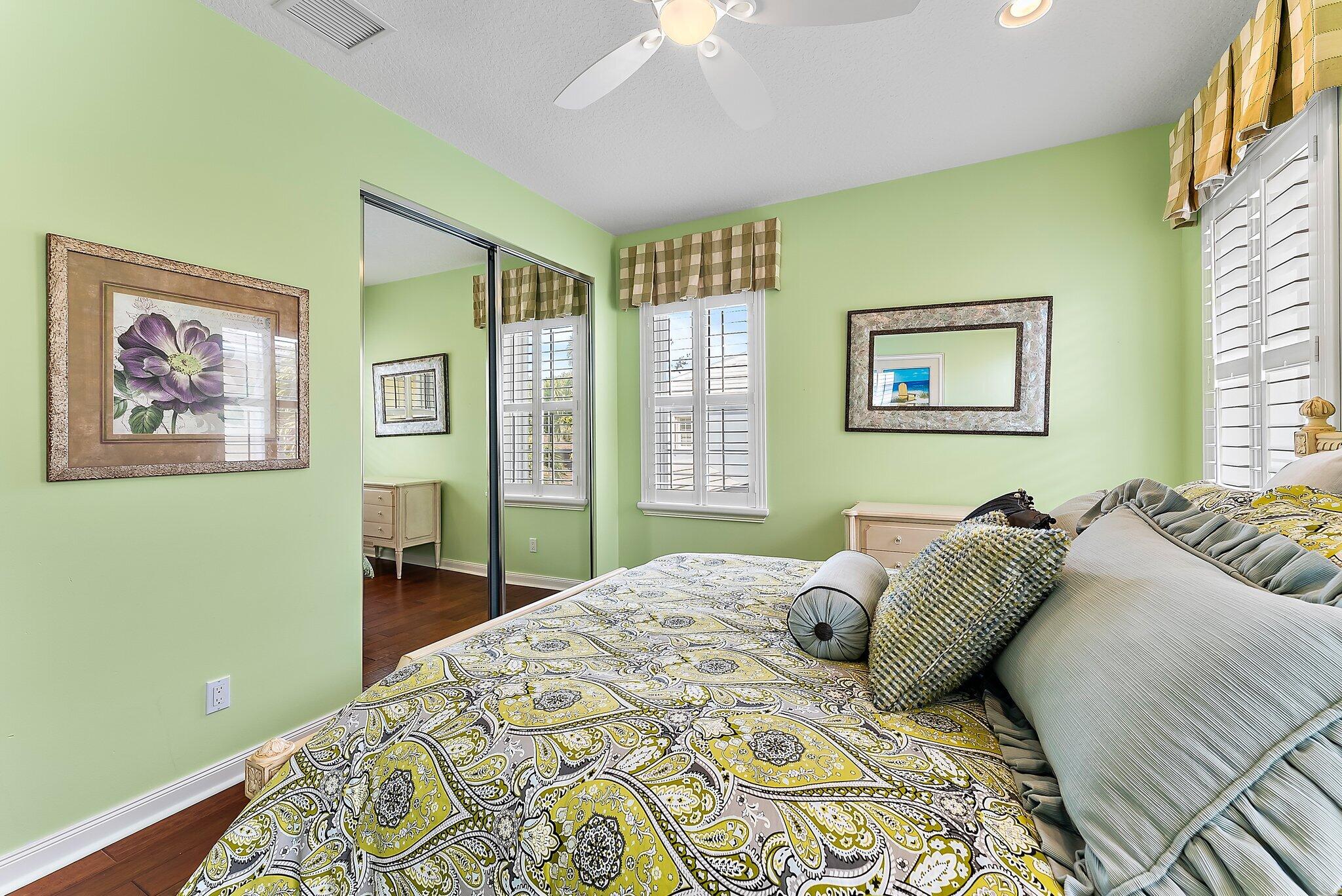 115 Castries Drive Jupiter, FL 33458 - Photo 33 of 60 a bedroom with a bed and a painting on the wall