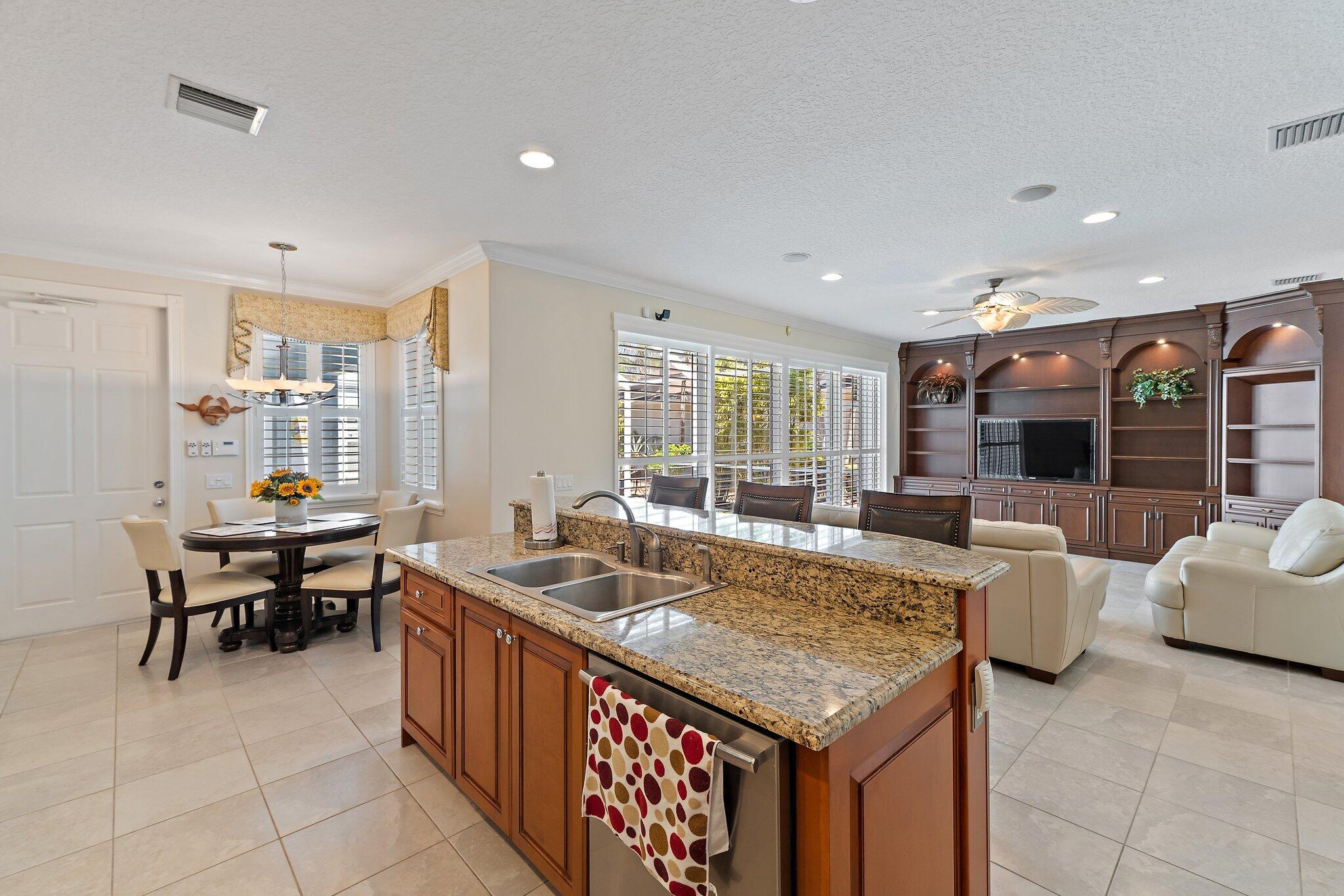 115 Castries Drive Jupiter, FL 33458 - Photo 7 of 60 a living room with stainless steel appliances granite countertop furniture a couch and a view of kitchen