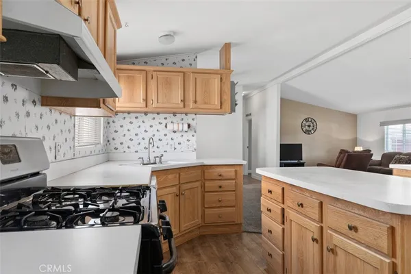 a kitchen with stainless steel appliances granite countertop a sink stove and cabinets