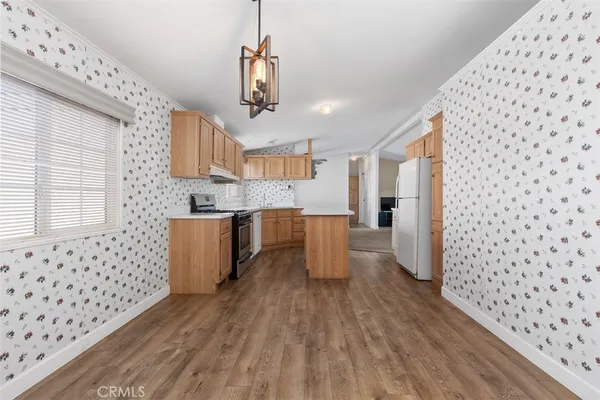 a kitchen with granite countertop a sink and wooden floor