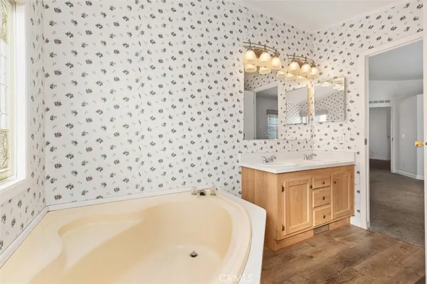 a bathroom with a bathtub sink and mirror
