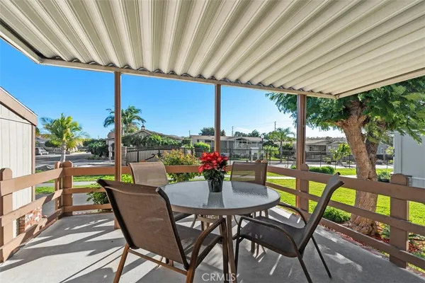 a view of an outdoor dining space with furniture and outdoor view