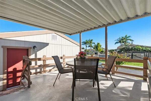 a view of an outdoor dining space with a table and chairs