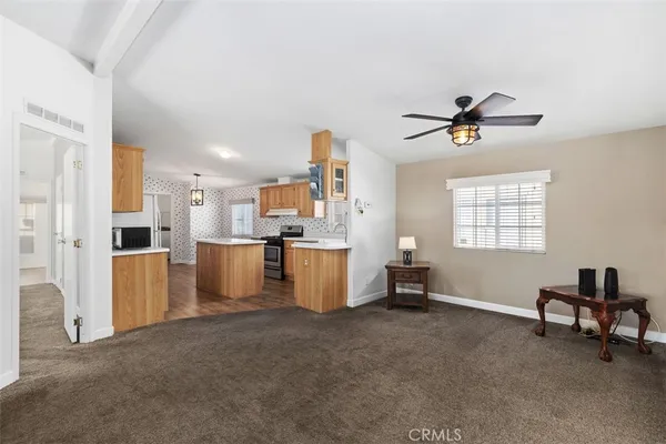 a living room with furniture and a ceiling fan