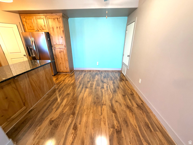 3618 Clear Rock Road, Unit 2 Eagle Mountain, UT 84005 - Photo 7 of 14 Wood-finish flooring throughout, complemented by a kitchen island with a dark countertop