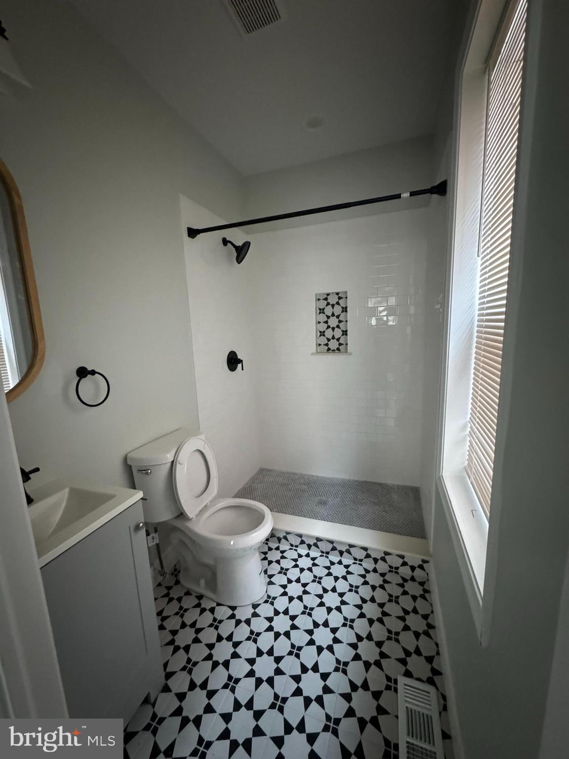 3218 Frederick Avenue Baltimore, MD 21229 - Photo 11 of 32 a bathroom with a toilet a sink and a shower