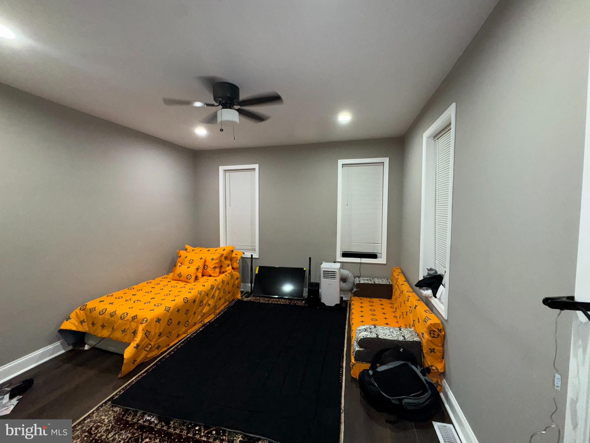 3218 Frederick Avenue Baltimore, MD 21229 - Photo 13 of 32 a bed room with a bed and a chandelier