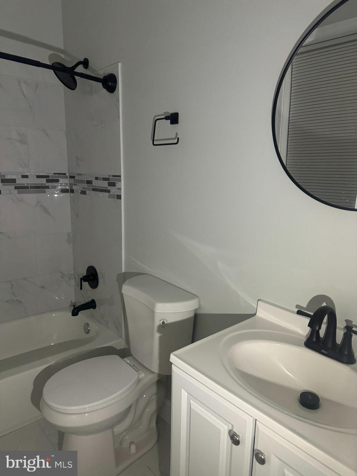 3218 Frederick Avenue Baltimore, MD 21229 - Photo 14 of 32 a bathroom with a sink and mirror
