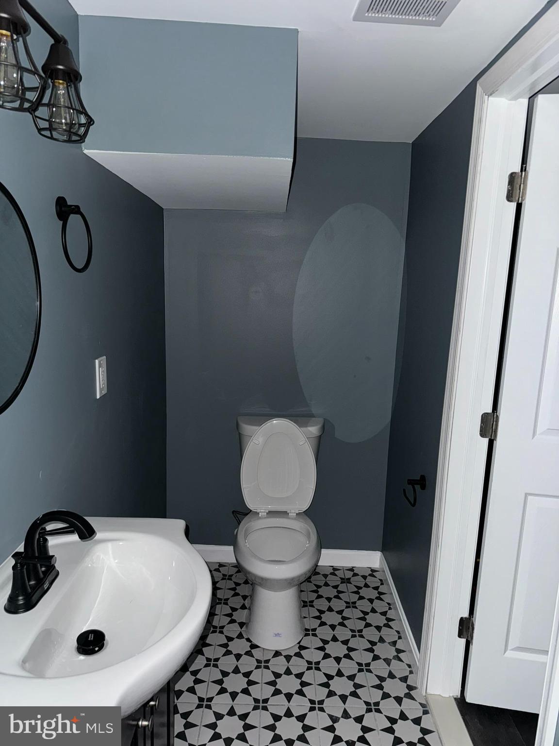 3218 Frederick Avenue Baltimore, MD 21229 - Photo 17 of 32 a bathroom with a sink toilet and a mirror