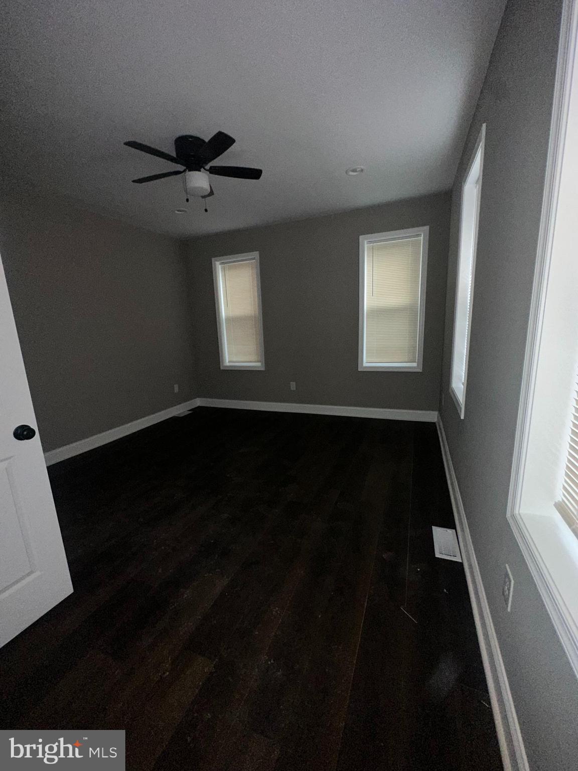 3218 Frederick Avenue Baltimore, MD 21229 - Photo 19 of 32 wooden floor in an empty room with a window