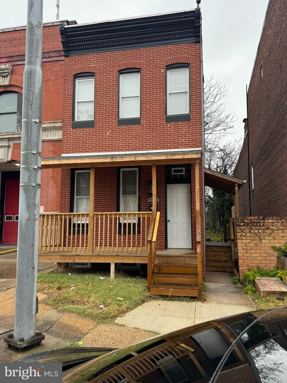 3218 Frederick Avenue Baltimore, MD 21229 - Photo 2 of 32 a front view of a house with a yard