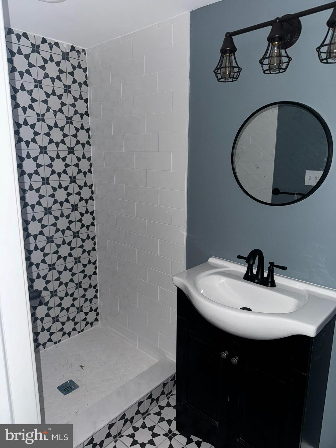 3218 Frederick Avenue Baltimore, MD 21229 - Photo 22 of 32 a bathroom with a sink and a mirror
