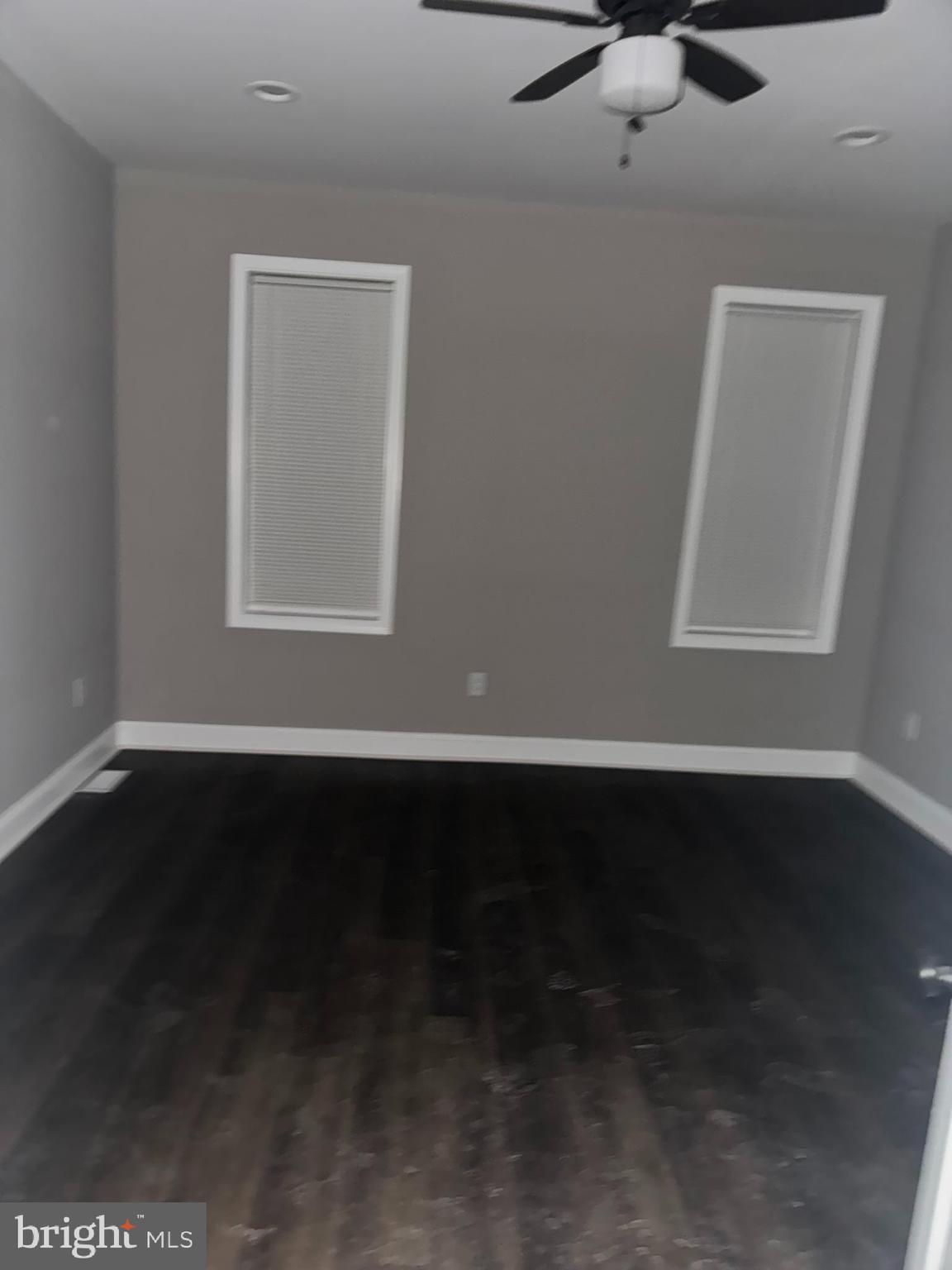 3218 Frederick Avenue Baltimore, MD 21229 - Photo 25 of 32 a view of an empty room with wooden floor and a window