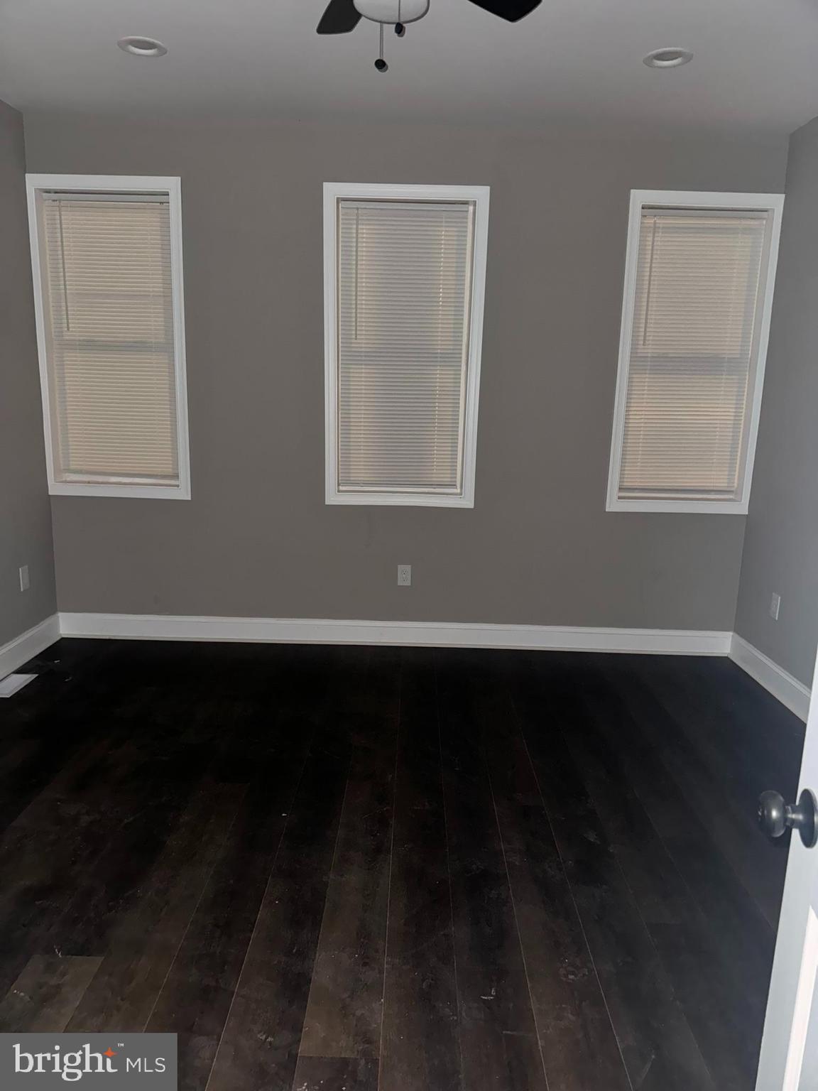 3218 Frederick Avenue Baltimore, MD 21229 - Photo 27 of 32 a view of an empty room with wooden floor and a window