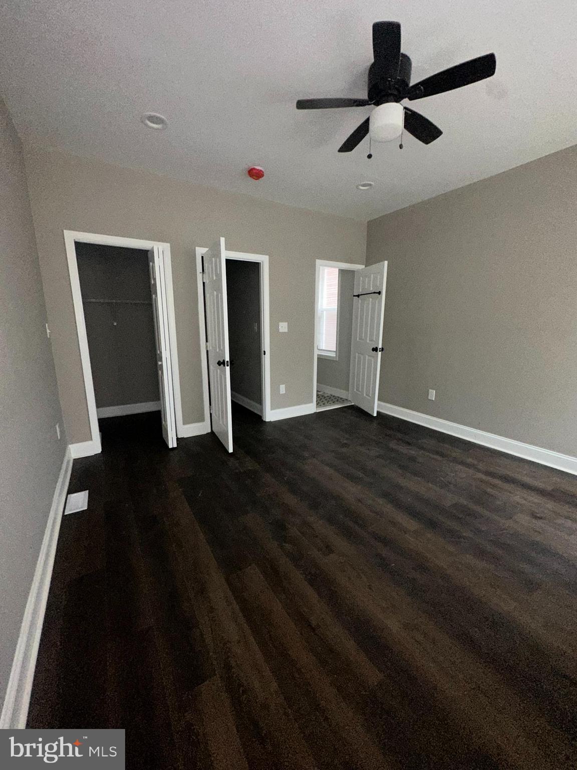 3218 Frederick Avenue Baltimore, MD 21229 - Photo 30 of 32 a view of an empty room with wooden floor and a ceiling fan