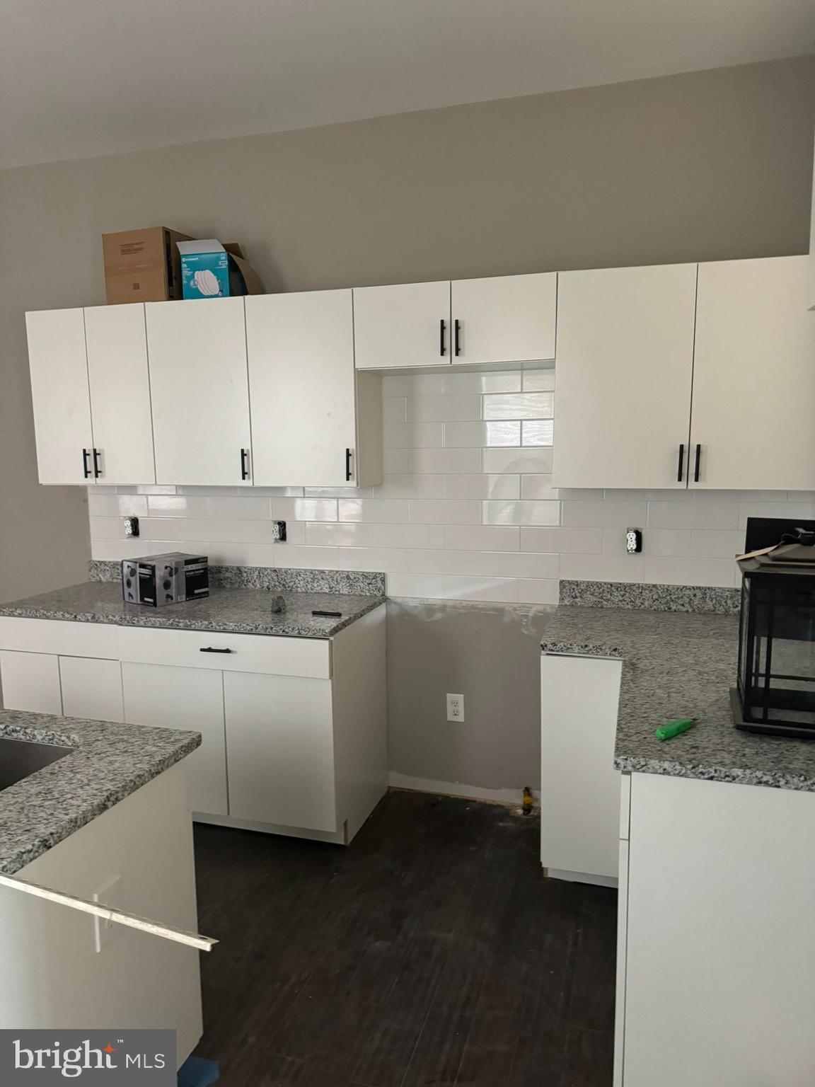 3218 Frederick Avenue Baltimore, MD 21229 - Photo 6 of 32 a kitchen with cabinets appliances a sink and a counter top space