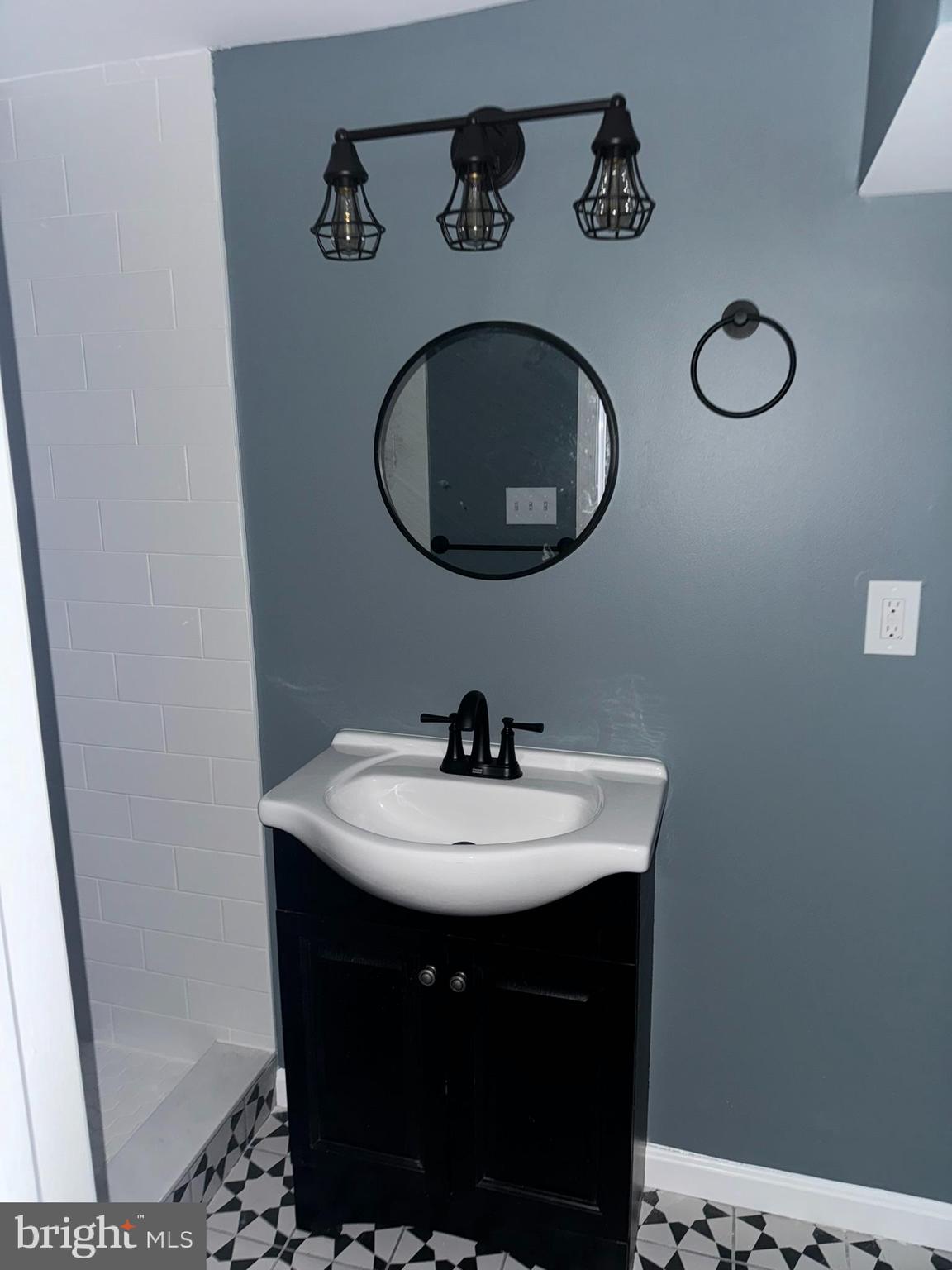 3218 Frederick Avenue Baltimore, MD 21229 - Photo 9 of 32 a bathroom with a sink and a mirror