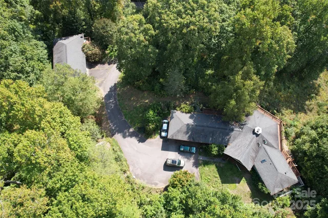 an aerial view of a house with yard swimming pool and outdoor seating