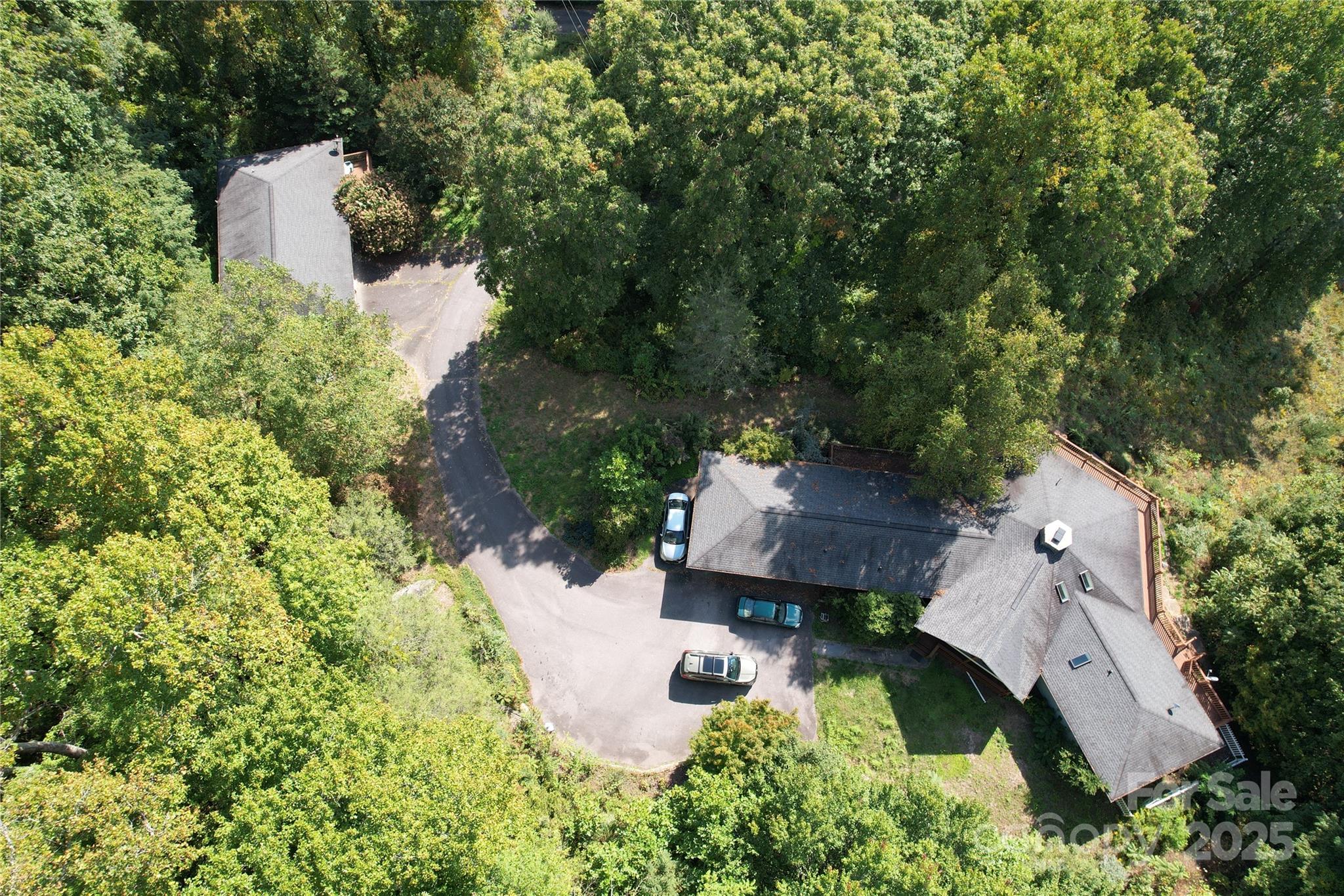 an aerial view of a house with yard swimming pool and outdoor seating