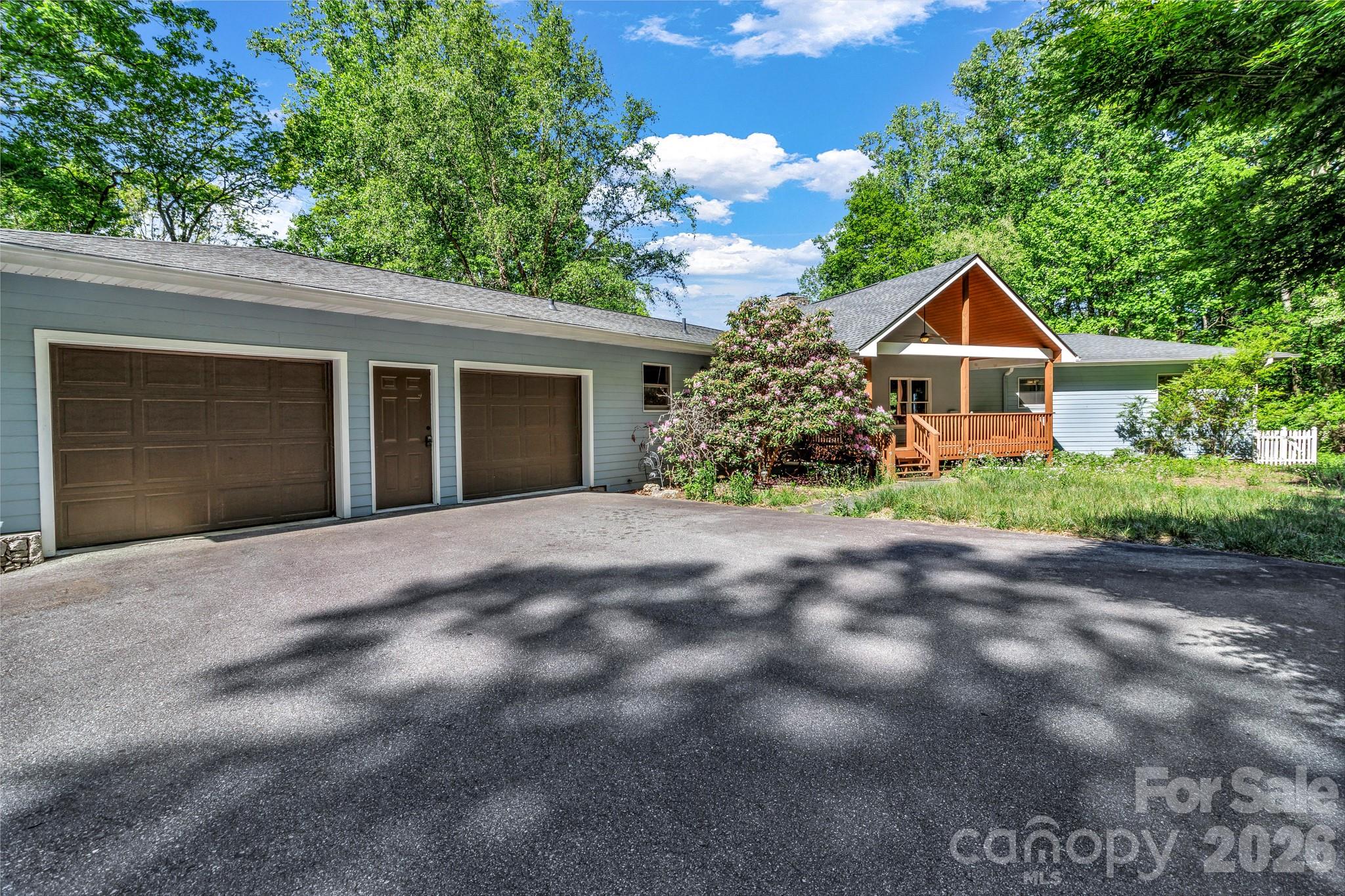 125 Winding Ridge Road Asheville, NC 28803 - Photo 1 of 48 a front view of house with yard and trees in the background