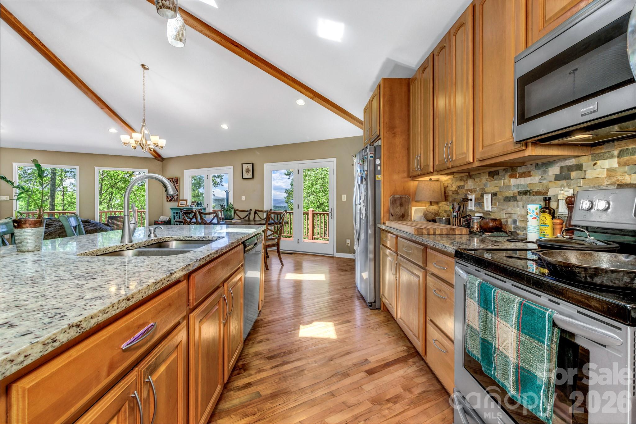 125 Winding Ridge Road Asheville, NC 28803 - Photo 13 of 48 a kitchen with stainless steel appliances granite countertop counter space a sink and cabinets