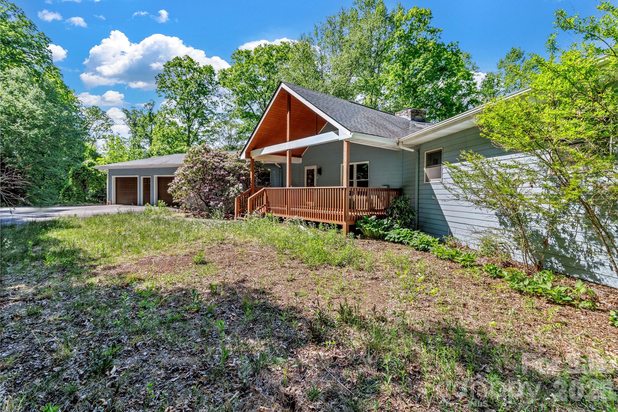 125 Winding Ridge Road Asheville, NC 28803 - Photo 2 of 48 a front view of house with yard and trees in the background