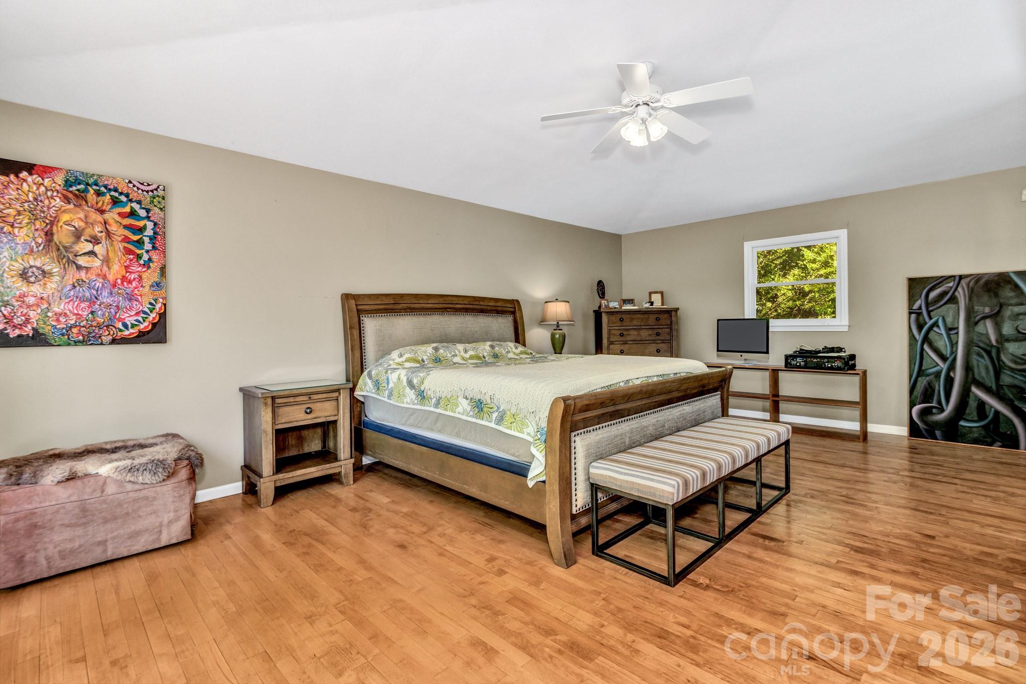 125 Winding Ridge Road Asheville, NC 28803 - Photo 21 of 48 a bedroom with a bed and a chandelier