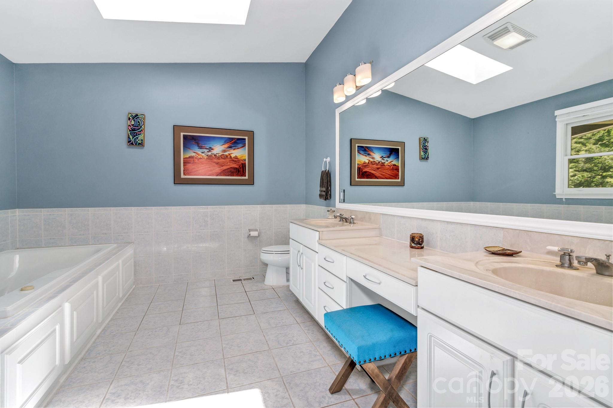 125 Winding Ridge Road Asheville, NC 28803 - Photo 23 of 48 a bathroom with a double vanity sink a tub and a shower