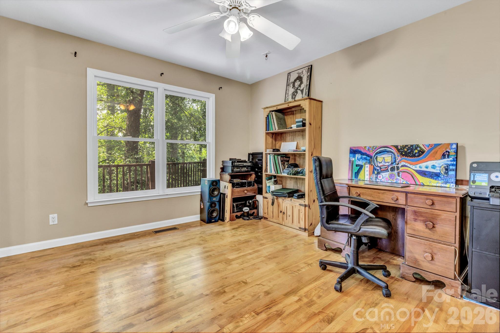 125 Winding Ridge Road Asheville, NC 28803 - Photo 26 of 48 a view of a workspace with furniture and a window