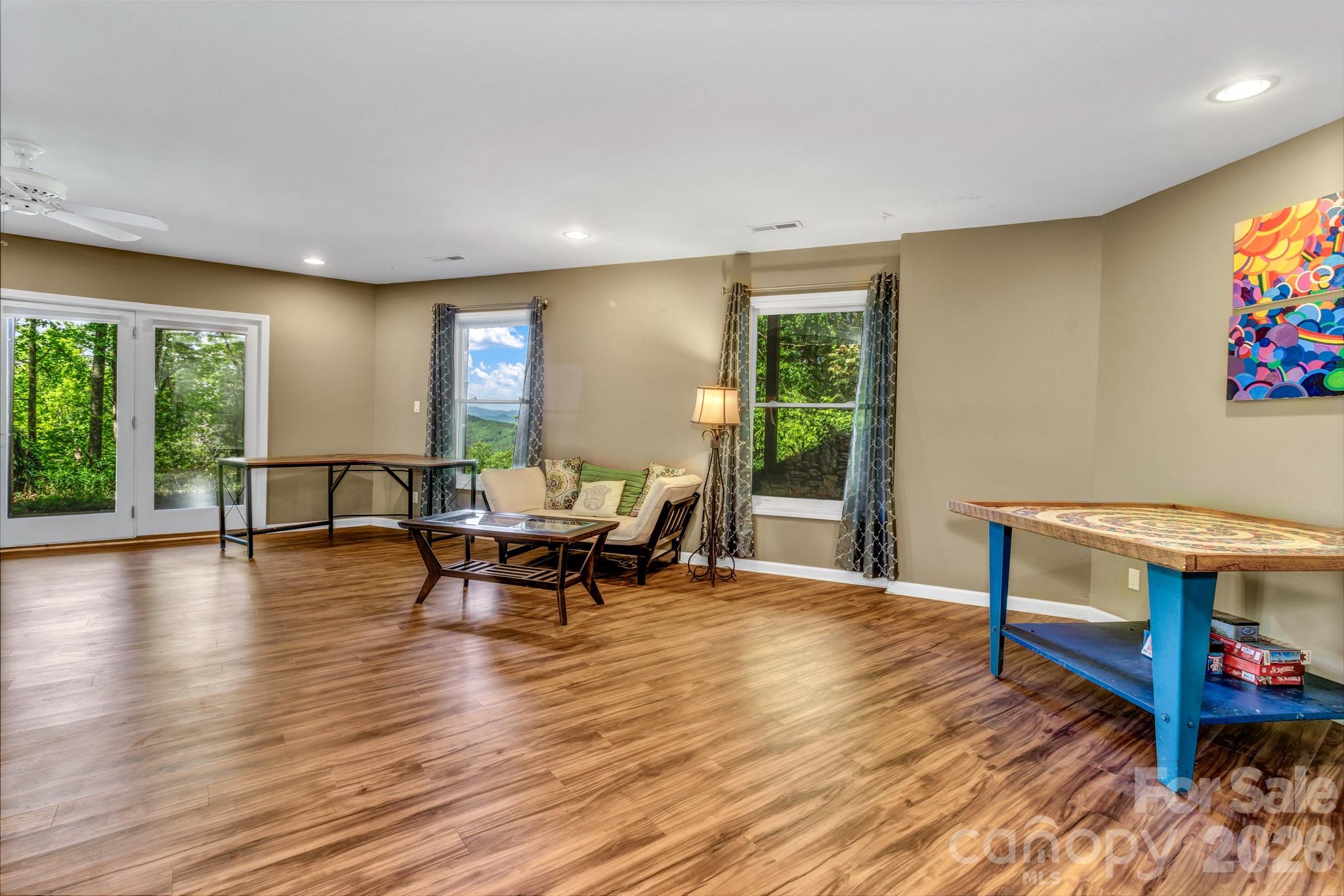 125 Winding Ridge Road Asheville, NC 28803 - Photo 28 of 48 a living room with furniture and a floor to ceiling window