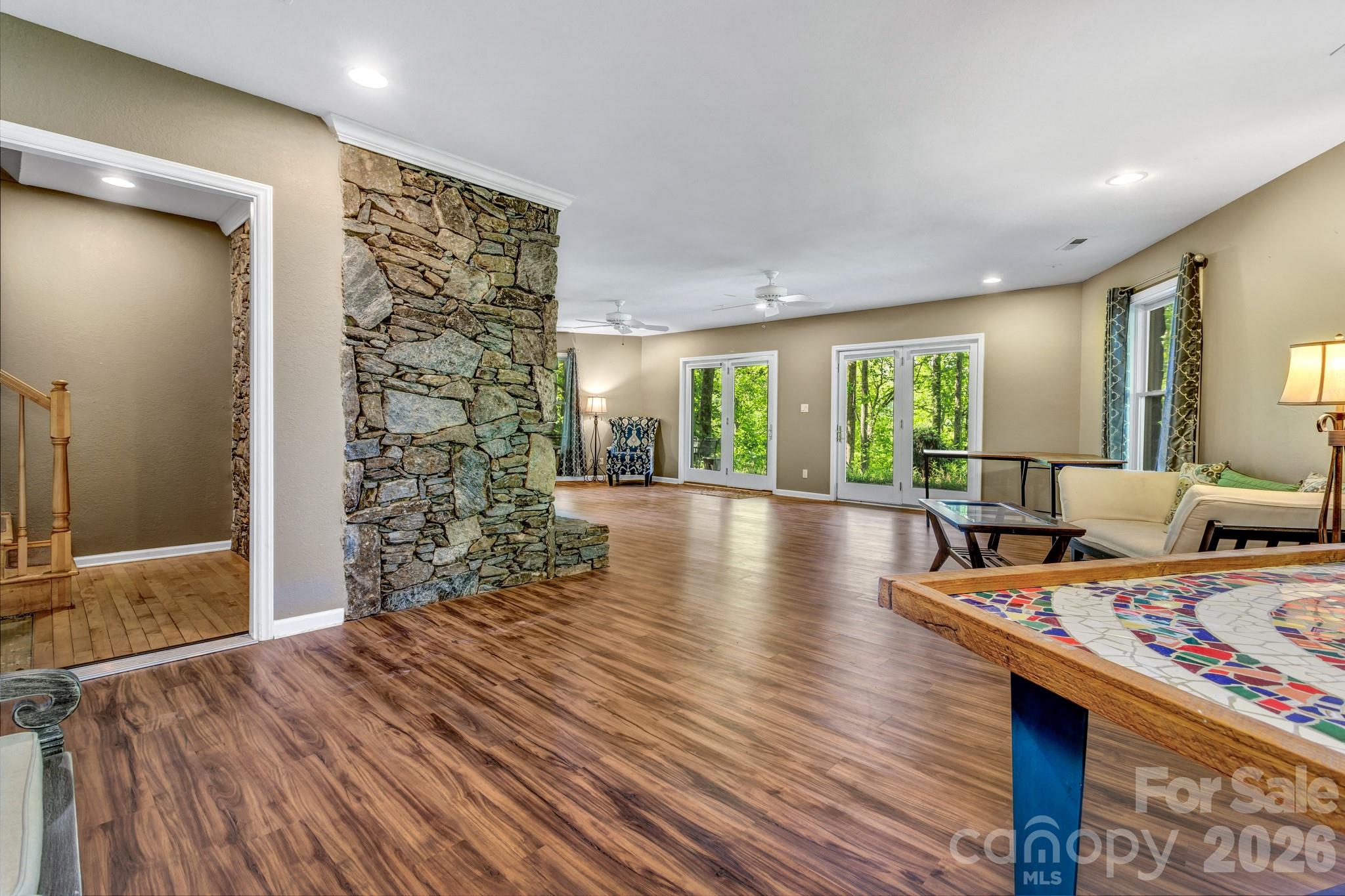125 Winding Ridge Road Asheville, NC 28803 - Photo 30 of 48 a room with furniture and a wooden floor