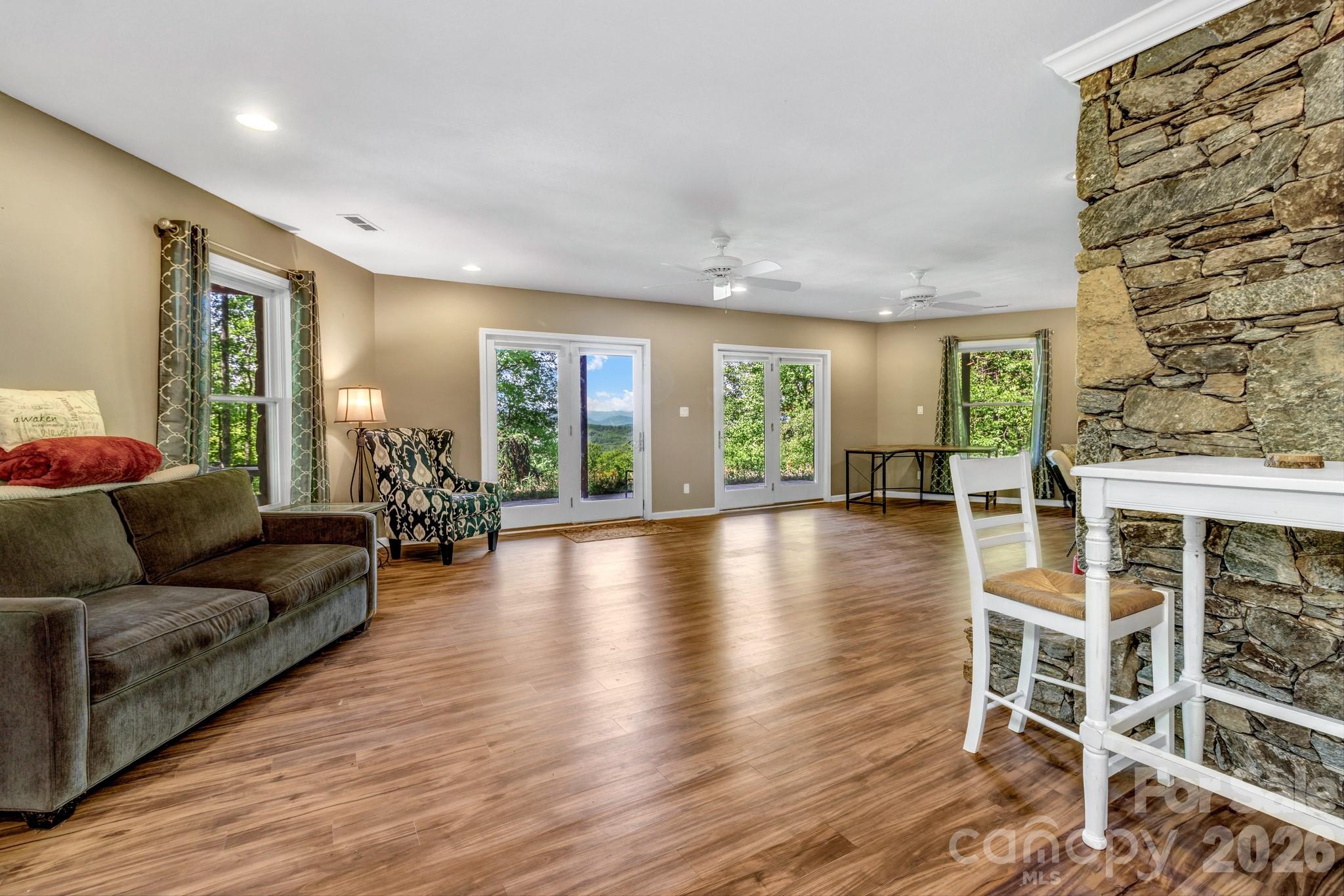 125 Winding Ridge Road Asheville, NC 28803 - Photo 35 of 48 a living room with furniture and a wooden floor