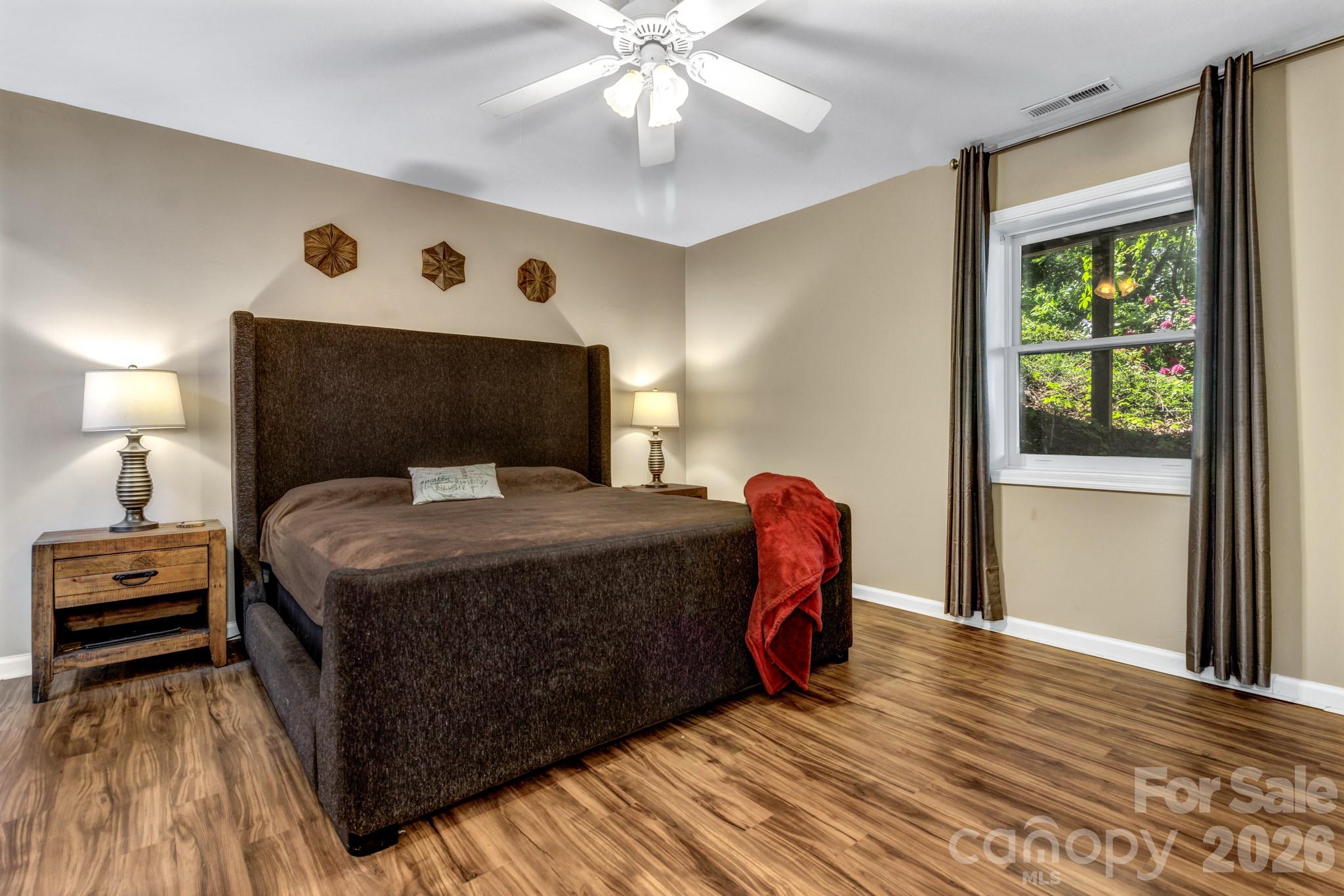125 Winding Ridge Road Asheville, NC 28803 - Photo 38 of 48 a bedroom with a bed and a mirror