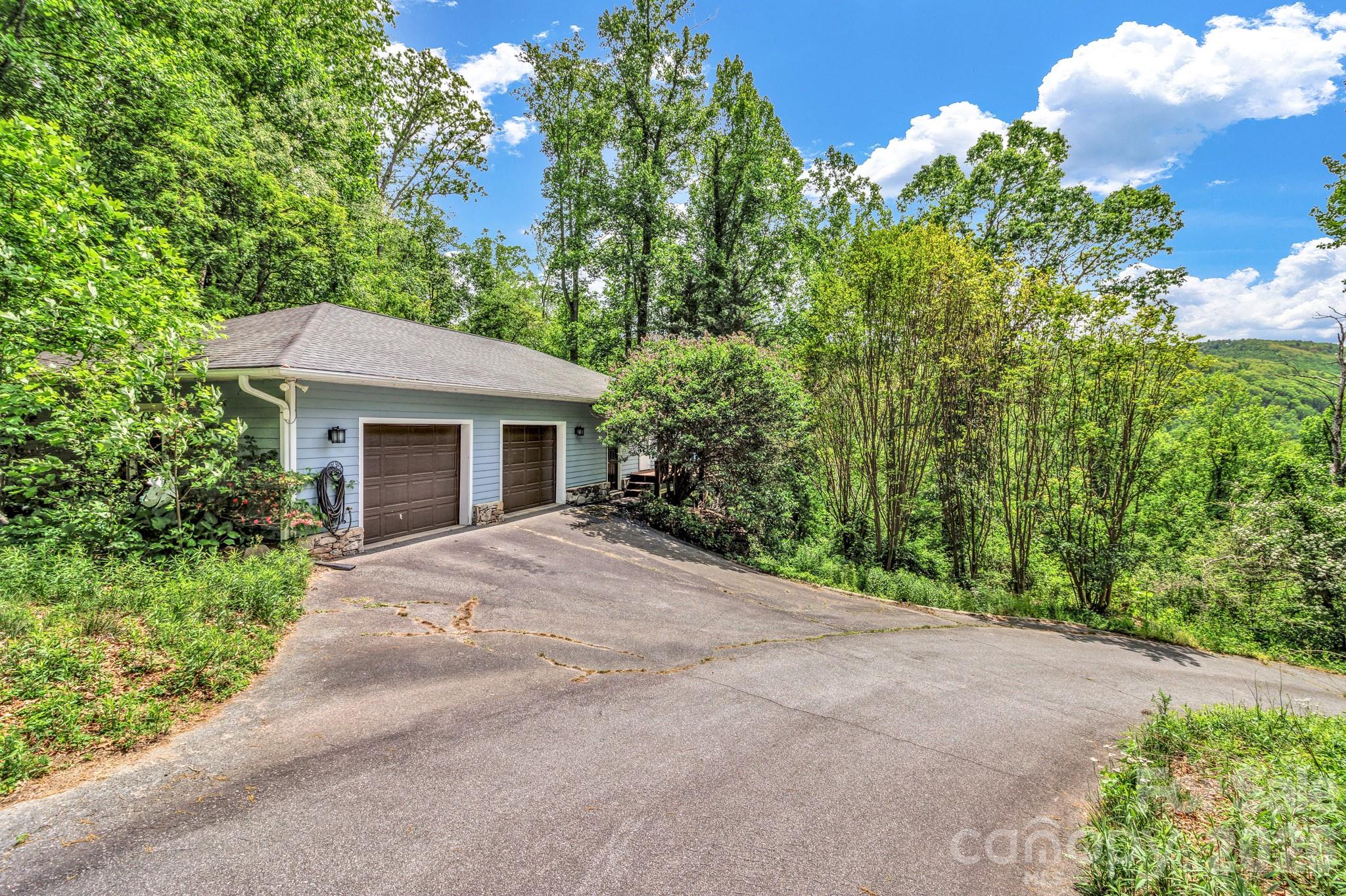 125 Winding Ridge Road Asheville, NC 28803 - Photo 43 of 48 front view of a house with a yard and potted plants