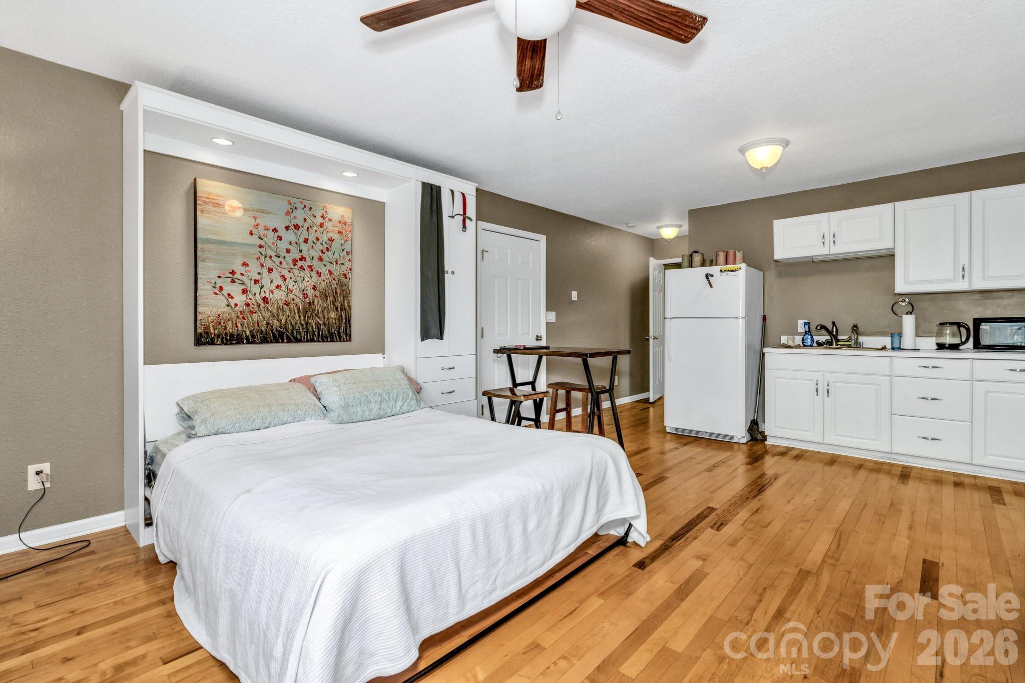 125 Winding Ridge Road Asheville, NC 28803 - Photo 44 of 48 a spacious bedroom with a bed and a large window