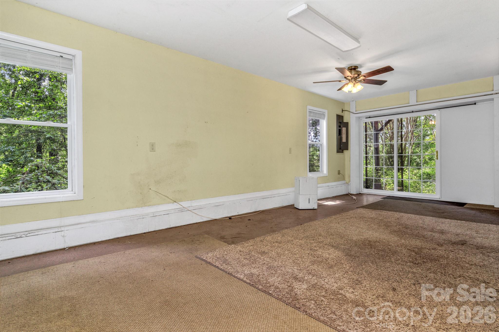125 Winding Ridge Road Asheville, NC 28803 - Photo 47 of 48 an empty room with windows and ceiling fan