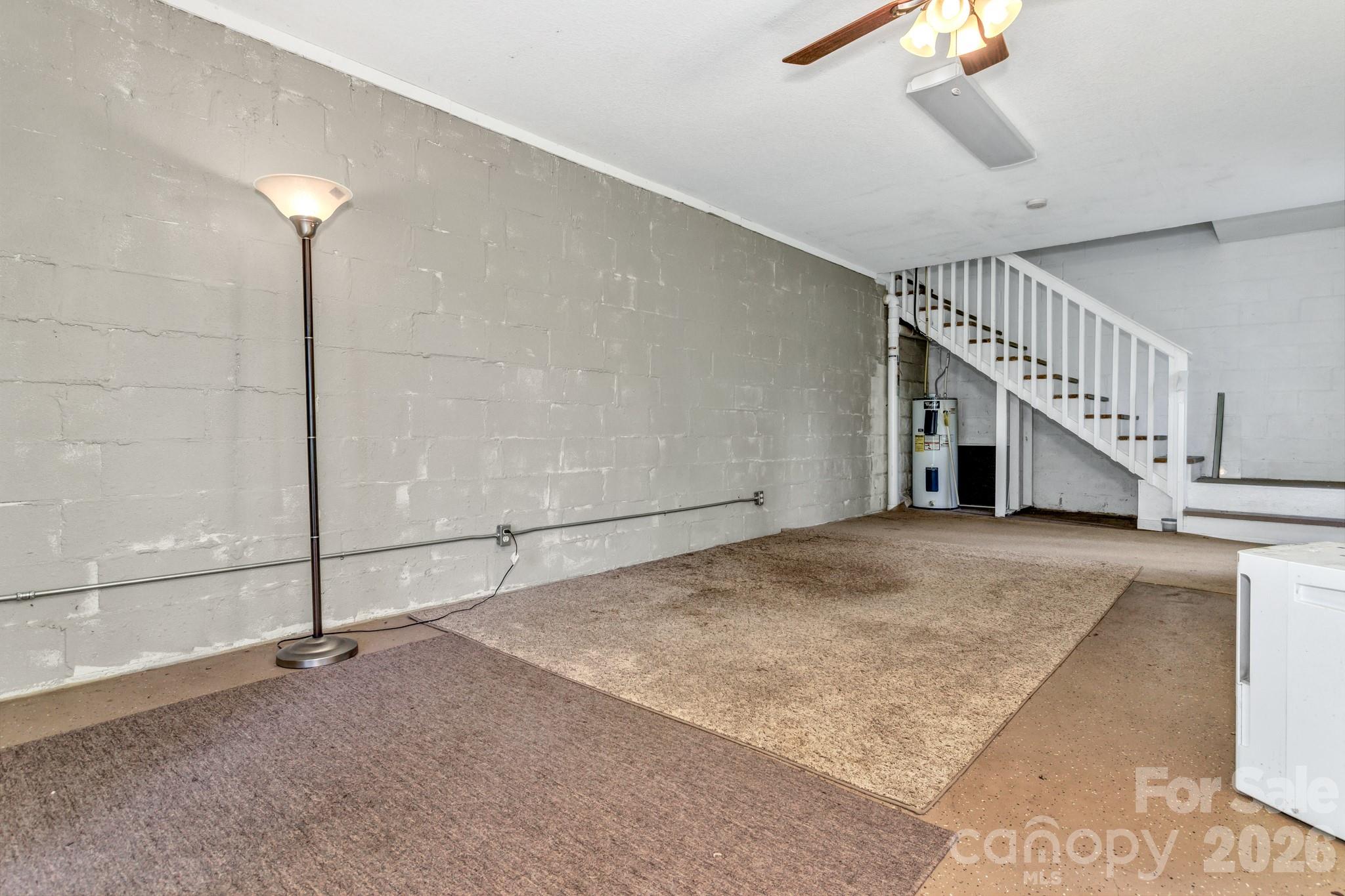 125 Winding Ridge Road Asheville, NC 28803 - Photo 48 of 48 a view of an empty room with stairs and a ceiling fan