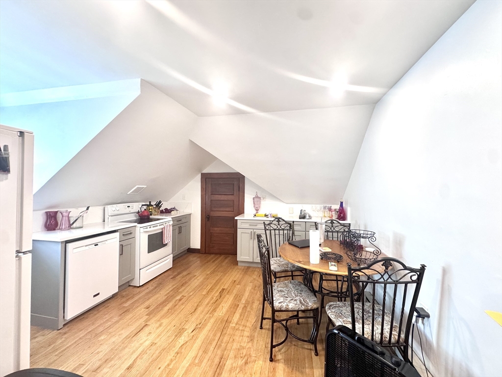 22 Greenough Street, Unit 3 Brookline, MA 02445 - Photo 1 of 14 a view of a dining room with furniture and wooden floor