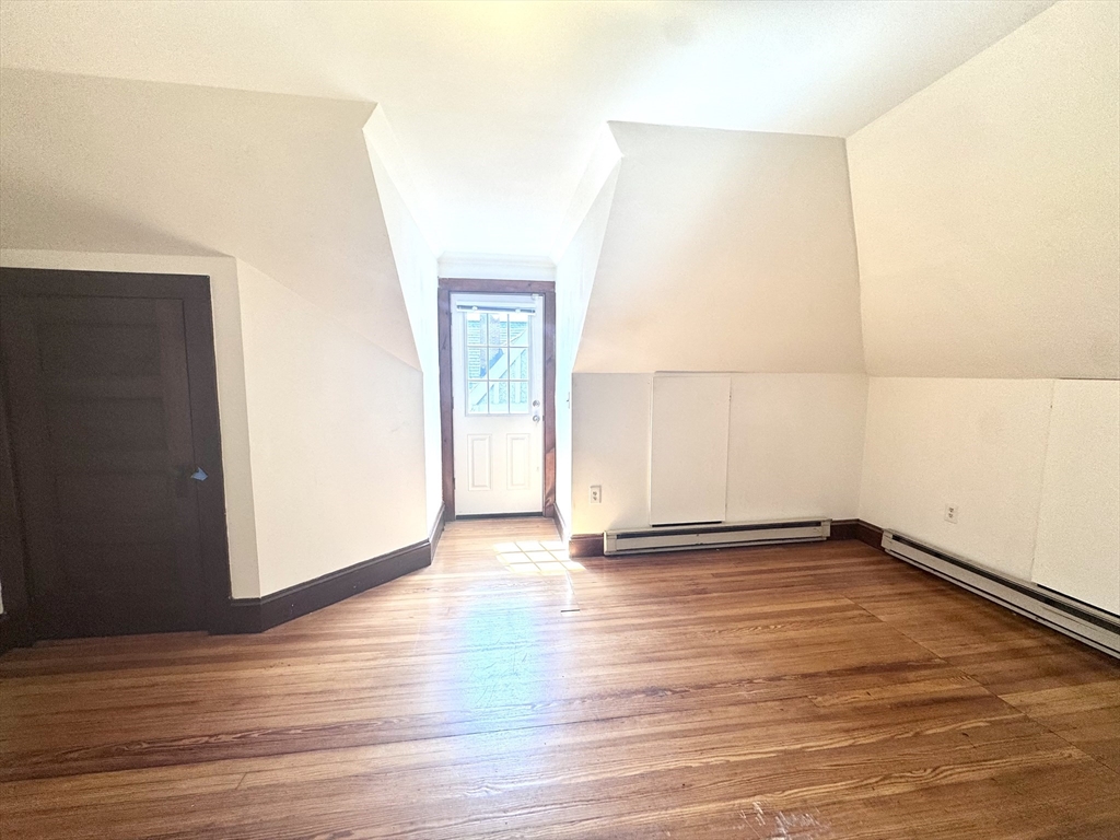 22 Greenough Street, Unit 3 Brookline, MA 02445 - Photo 11 of 14 a view of an empty room with wooden floor