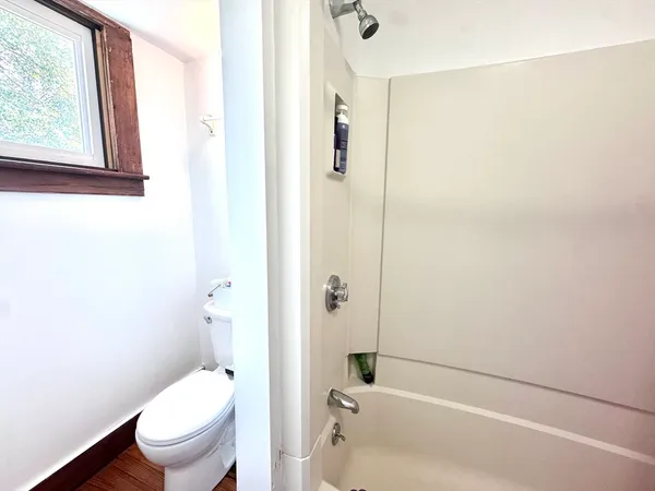a bathroom with a toilet and a bathtub