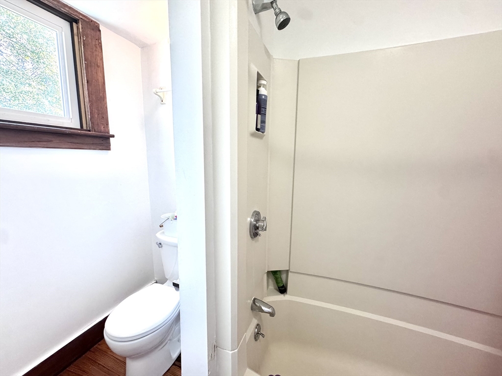 22 Greenough Street, Unit 3 Brookline, MA 02445 - Photo 4 of 14 a bathroom with a toilet and a bathtub