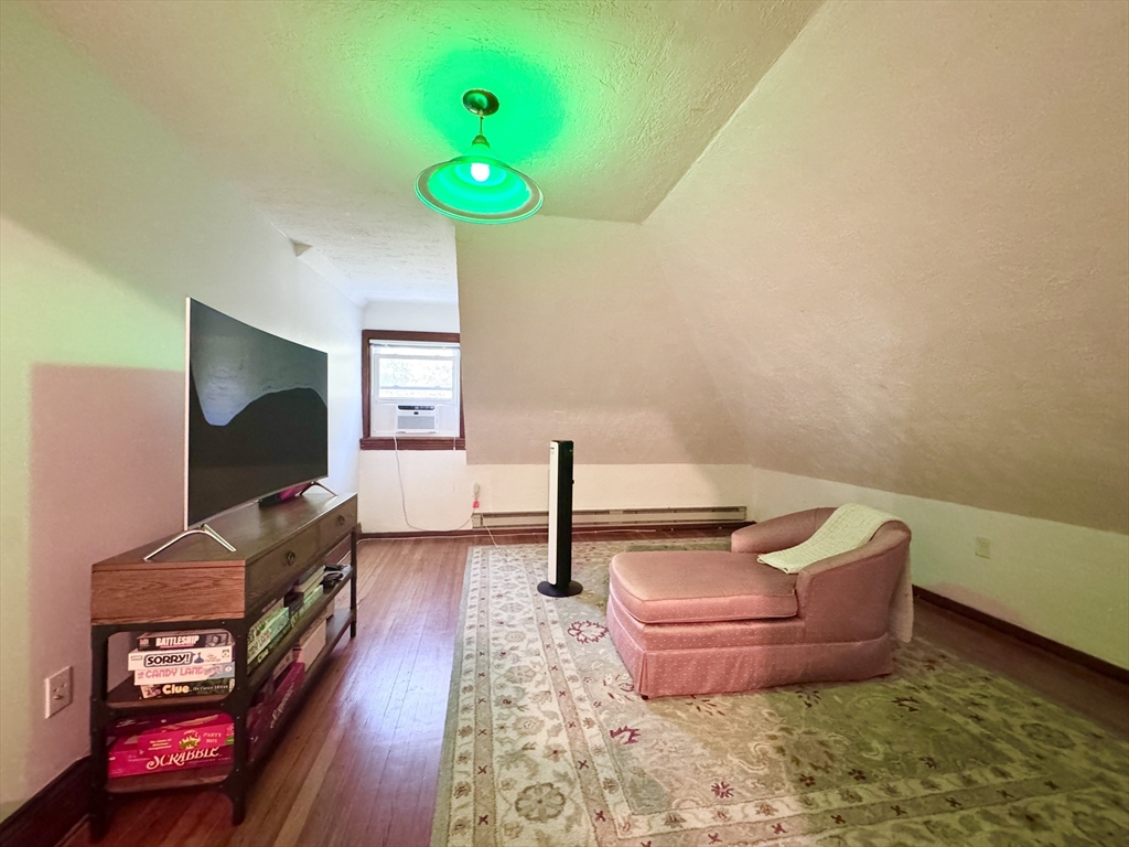 22 Greenough Street, Unit 3 Brookline, MA 02445 - Photo 5 of 14 a living room with furniture and a flat screen tv