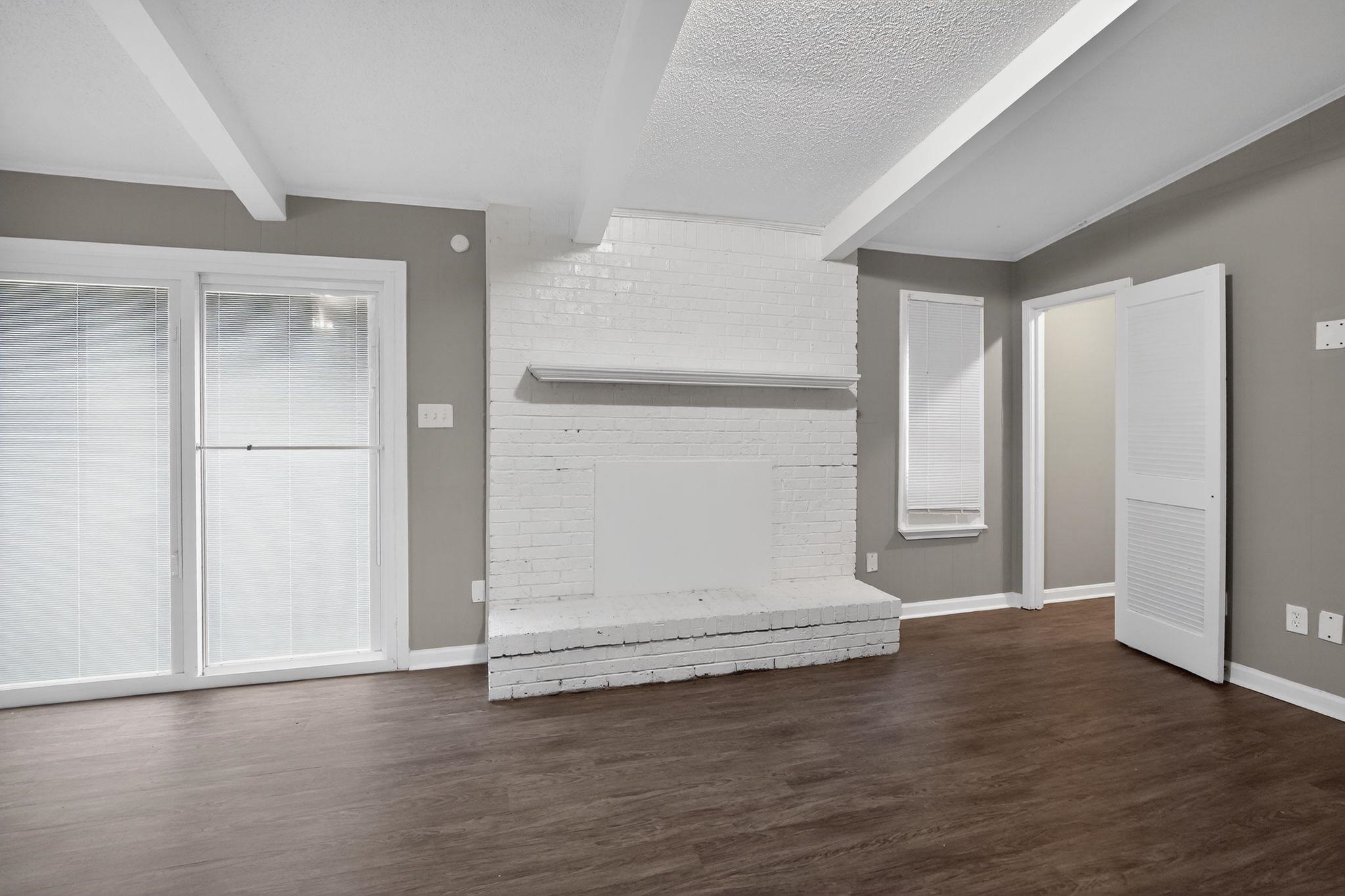 3603 England Street Memphis, TN 38127 - Photo 34 of 36 Below grade area featuring a fireplace, dark wood-style floors, and a textured ceiling