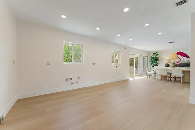 an empty room with furniture and window